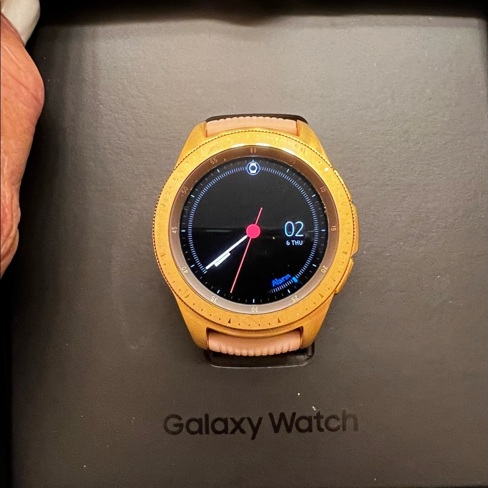 Samsung watch, charger, and extra watch bands.